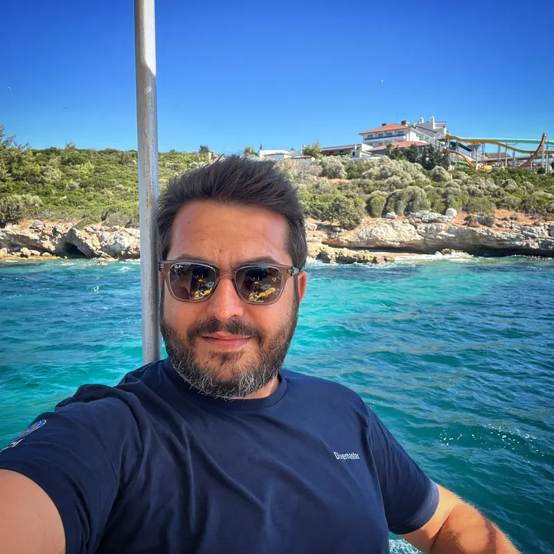 Taylan Kırali on a dive boat over turquoise water